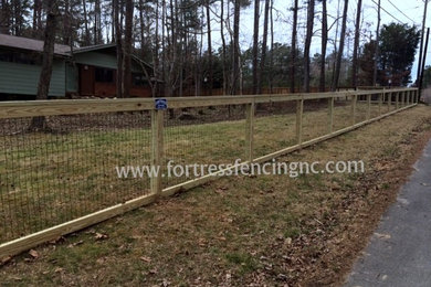 simple post and frame fence with black vinyl coated wire insert