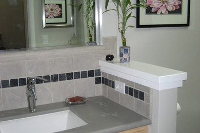 Inspiration for a contemporary bathroom remodel in San Francisco with shaker cabinets and solid surface countertops
