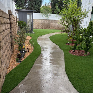 Curved Concrete Walkway with Artificial Turf & Modern Planter Design | Winnetka,