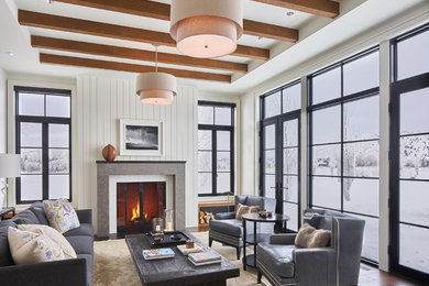 Example of a country medium tone wood floor and brown floor living room design in Other with white walls and a standard fireplace