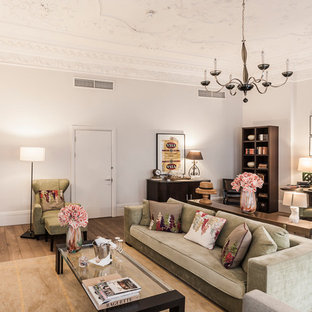Photo of a traditional open plan living room in London with white walls, medium hardwood flooring and a standard fireplace.