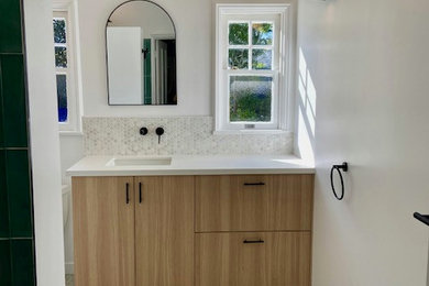 Example of a mid-sized trendy 3/4 green tile and ceramic tile terrazzo floor, multicolored floor and single-sink bathroom design in Los Angeles with flat-panel cabinets, light wood cabinets, a one-piece toilet, white walls, quartz countertops, white countertops and a floating vanity