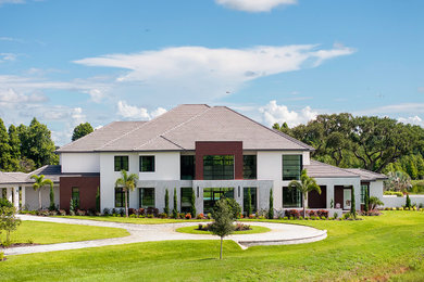 Example of a huge trendy multicolored two-story mixed siding exterior home design in Tampa with a shingle roof