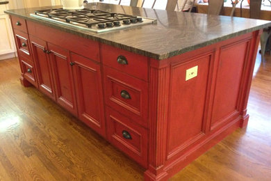 Example of a trendy kitchen design in New York with red cabinets and marble countertops