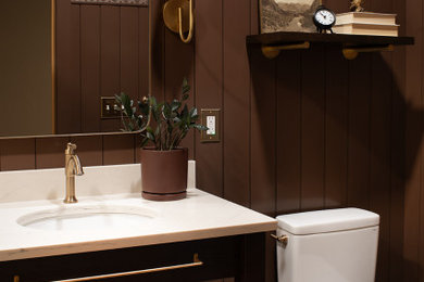 Inspiration for a small transitional beige tile and porcelain tile porcelain tile, beige floor and wainscoting powder room remodel in Other with shaker cabinets, dark wood cabinets, brown walls, an undermount sink, quartz countertops, white countertops and a built-in vanity