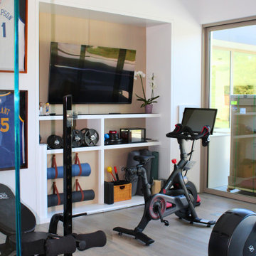 rchitectural Home Gym with Custom Storage and Media Wall