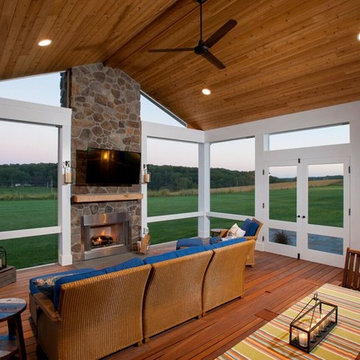 Design Builders screened porch with stone fireplace & Ipe deck in Sykesville MD