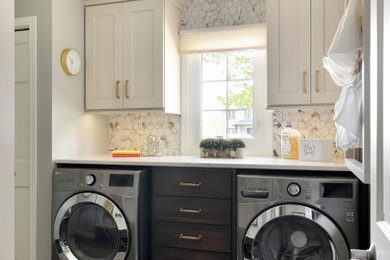 Inspiration for a mid-sized timeless galley ceramic tile and brown floor utility room remodel in Minneapolis with flat-panel cabinets, brown cabinets, quartz countertops, white backsplash, ceramic backsplash, gray walls, a side-by-side washer/dryer and white countertops