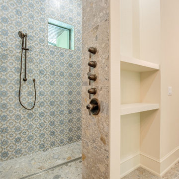 Mediterranean Shower with Built‑In Shelves & Patterned Tile