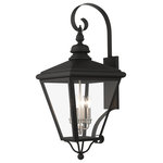 Livex Lighting Inc. - 4 Light Black Outdoor Extra Large Wall Lantern, Brushed Nickel - The stylish black finish outdoor Adams extra large wall lantern is a great way to update your home's exterior decor. A flat metal curved arm attaches the solid brass decorative housing to the square backplate while clear glass shows off the brushed nickel finish cluster.