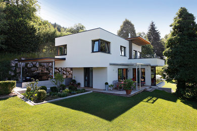 Modern white two-story flat roof idea in Other