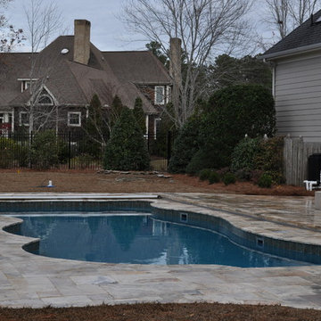 Fiberglass Swimming Pool with Travertine Decking and Automatic Cover