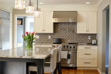 Example of a large classic single-wall light wood floor kitchen pantry design in Grand Rapids with an undermount sink, raised-panel cabinets, white cabinets, granite countertops, an island, gray backsplash, ceramic backsplash and stainless steel appliances