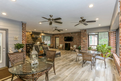 Inspiration for a huge enclosed family room remodel in Houston with a wall-mounted tv