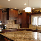 Delicatus Gold granite countertop with travertine back splashes ...