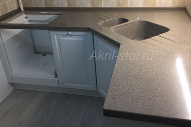 Design ideas for a small l-shaped kitchen in Moscow with a double-bowl sink, solid surface benchtops and brown benchtop.