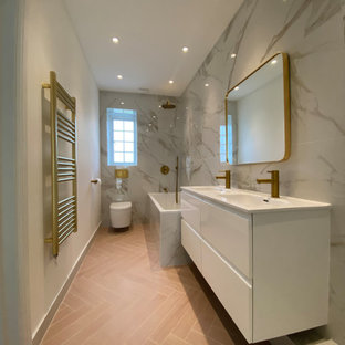 Inspiration for a large contemporary kids bathroom in London with flat-panel cabinets, white cabinets, a corner shower, a wall-mount toilet, porcelain tile, multi-coloured walls, porcelain floors, pink floor, a hinged shower door, a niche, a double vanity and a floating vanity.