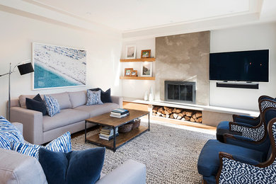 Mid-sized transitional open concept family room in Toronto with white walls, medium hardwood floors, a standard fireplace, a concrete fireplace surround and a wall-mounted tv.