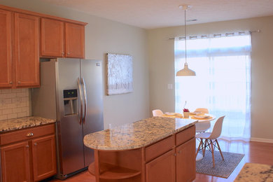 Bright kitchen and breakfast nook with warm cabinets