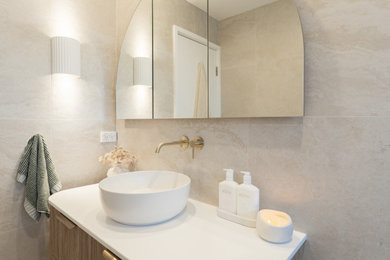 Mid-sized modern 3/4 bathroom in Sydney with flat-panel cabinets, medium wood cabinets, an open shower, a one-piece toilet, beige tile, a vessel sink, beige floor, an open shower, white benchtops, a niche, a single vanity and a floating vanity.