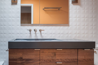 Inspiration for a mid-sized 1960s master white tile and porcelain tile porcelain tile, gray floor and single-sink bathroom remodel in Denver with flat-panel cabinets, medium tone wood cabinets, a two-piece toilet, orange walls, an integrated sink, concrete countertops, blue countertops, a niche and a floating vanity