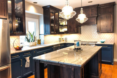 Large transitional l-shaped medium tone wood floor eat-in kitchen photo in Omaha with an undermount sink, shaker cabinets, blue cabinets, granite countertops, white backsplash, glass tile backsplash, stainless steel appliances, an island and gray countertops