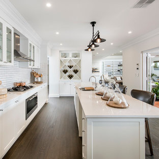 Contemporary kitchen pantry pictures - Example of a trendy galley kitchen pantry design in Perth with a double-bowl sink, white backsplash, subway tile backsplash, stainless steel appliances and an island