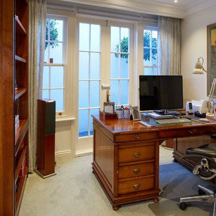 Design ideas for a small eclectic fully buried basement in London with white walls, carpet and green floors.