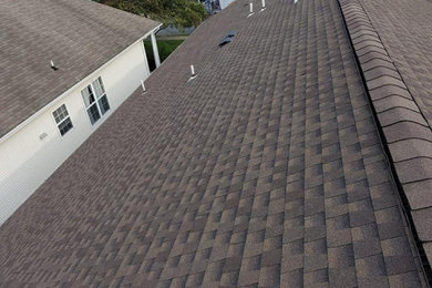 Inspiration for an exterior home remodel in Newark with a hip roof, a shingle roof and a brown roof