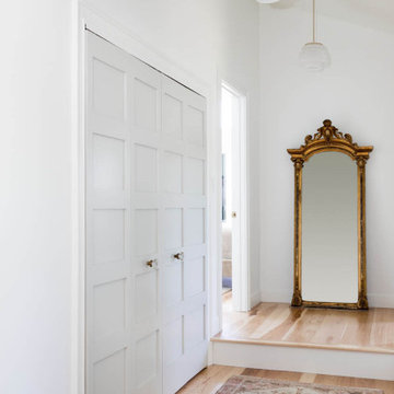 Light-Filled Entryway with Paneled Doors and Antique Mirror – Cape Ann MA
