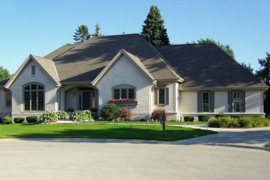 Elegant white one-story mixed siding exterior home photo in Milwaukee