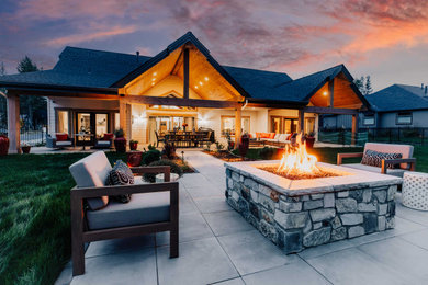 Example of a large trendy backyard concrete paver patio design in Other with a fire pit