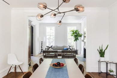 Large transitional medium tone wood floor and brown floor great room photo in Raleigh with white walls and no fireplace