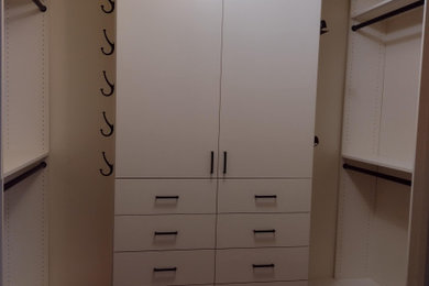Closet with drawers, doors, shelves, closet rod and hooks.