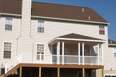 Mid-sized elegant backyard deck photo in Philadelphia with a roof extension