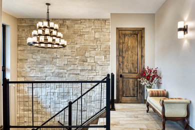 Example of a large mountain style tile u-shaped metal railing and brick wall staircase design in Salt Lake City with tile risers