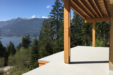 Deck - mid-sized transitional backyard deck idea in Vancouver with a roof extension