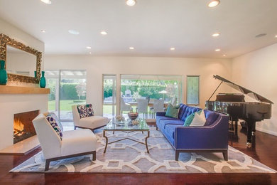 Mid-sized transitional formal and open concept dark wood floor living room photo in Los Angeles with white walls, a standard fireplace, a plaster fireplace and no tv