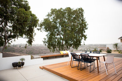 This is an example of a mid-sized contemporary backyard deck in San Diego.
