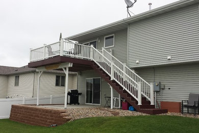 Example of a backyard deck design in Other with no cover
