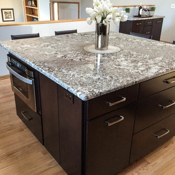 Cherry cabinets with slab doors, a custom-mixed stain, Bianco Antico granite and