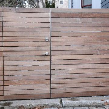 An ipe fence and gate provide a separation between public and private spaces.