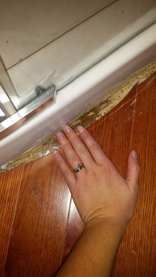 Fill gap between shower base and hardwood floor?