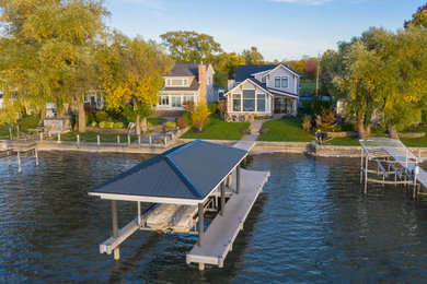 Inspiration for a mid-sized coastal gray two-story concrete fiberboard and clapboard exterior home remodel in Other with a shingle roof and a black roof