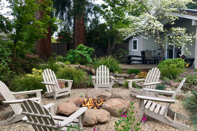 Large elegant backyard stone patio photo in Other with a fire pit and no cover