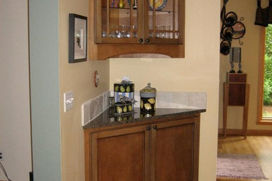 Open concept kitchen - mid-sized transitional l-shaped dark wood floor open concept kitchen idea in Milwaukee with a double-bowl sink, recessed-panel cabinets, dark wood cabinets, beige backsplash, stone tile backsplash, stainless steel appliances, an island and granite countertops