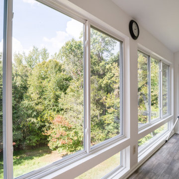 Panoramic Sunroom Windows with Tree-Filled Backyard Views