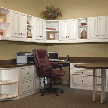 Home office with extended round table and lots of storage and wall cabinets