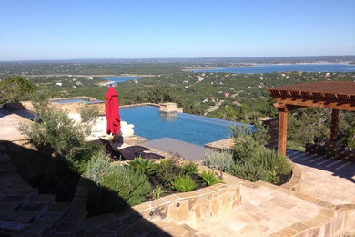 Inspiration for a mid-sized contemporary backyard concrete paver and rectangular infinity hot tub remodel in Austin