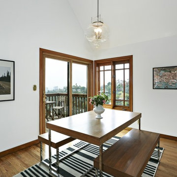 Dining table with benches, art prints, striped rug